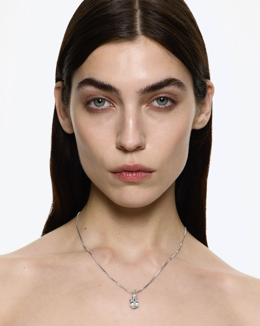 Model wearing Alan Crocetti White Topaz Gem In heat necklace