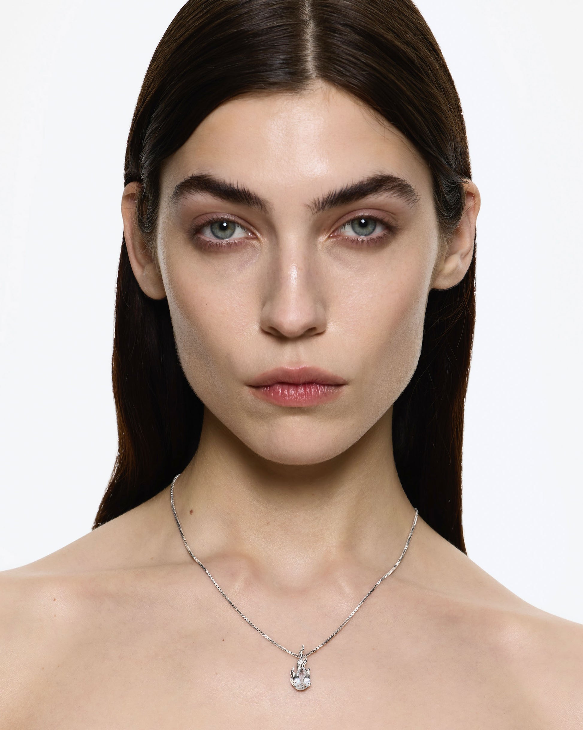 Model wearing Alan Crocetti White Topaz Gem In heat necklace
