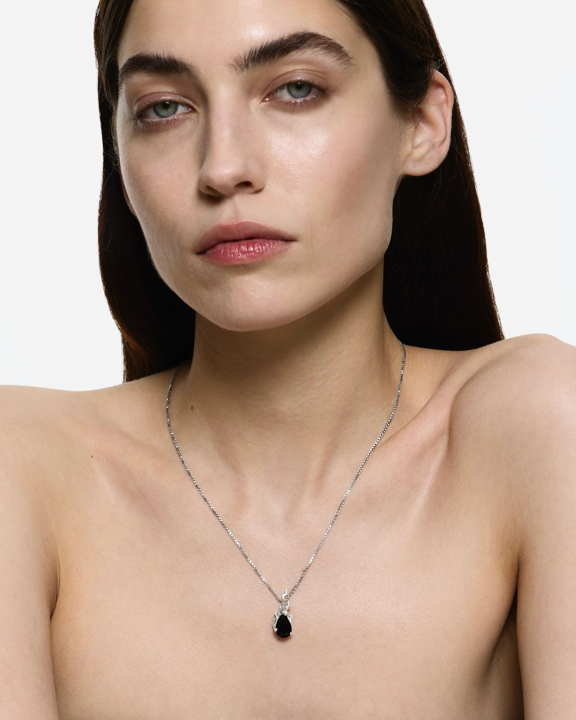 Model wearing Alan Crocetti Gem In Heat Black Onyx Necklace in rhodium vermeil