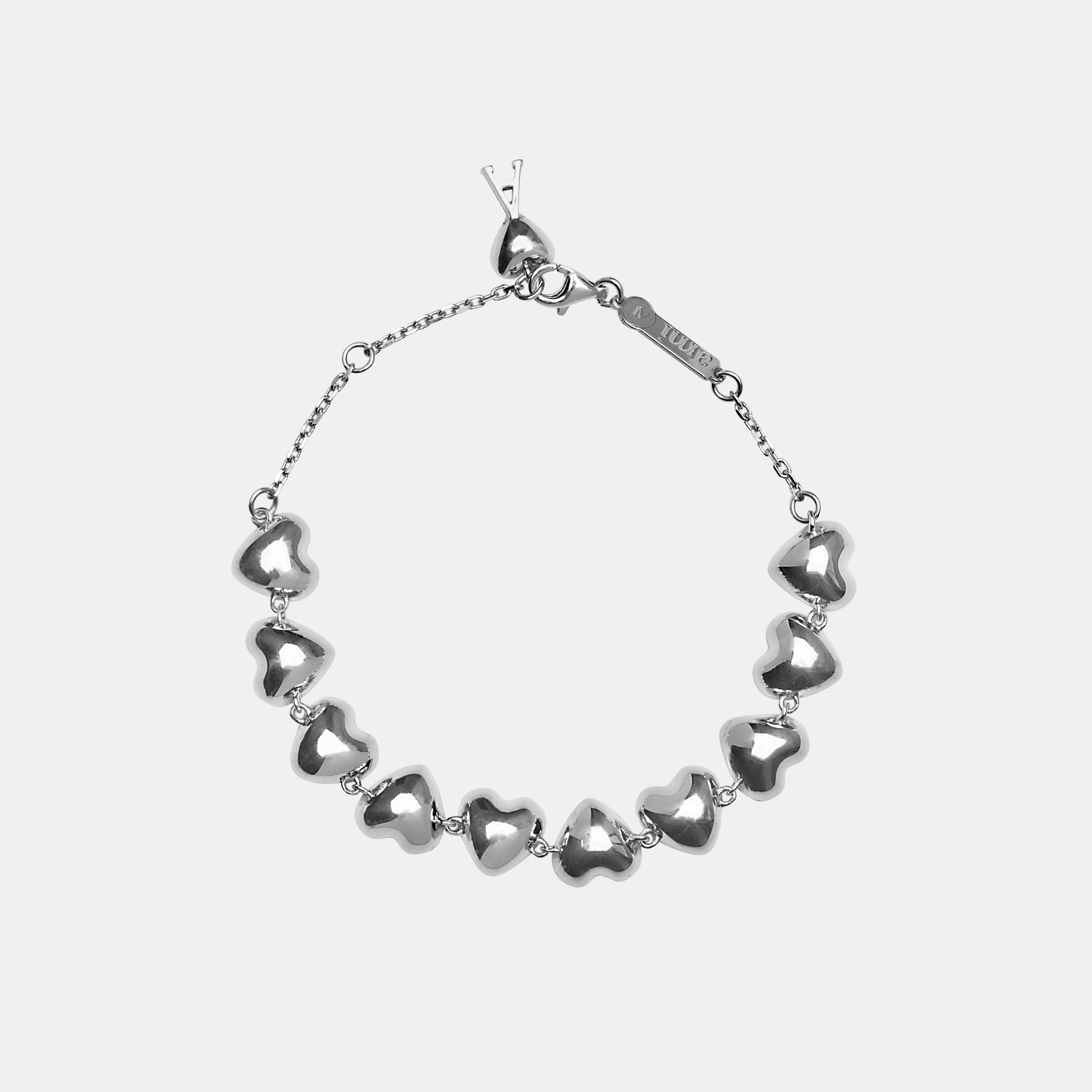 Silver heart-shaped bracelet on a light gray background