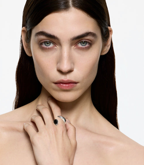 Sculptural black onyx ring worn on hand