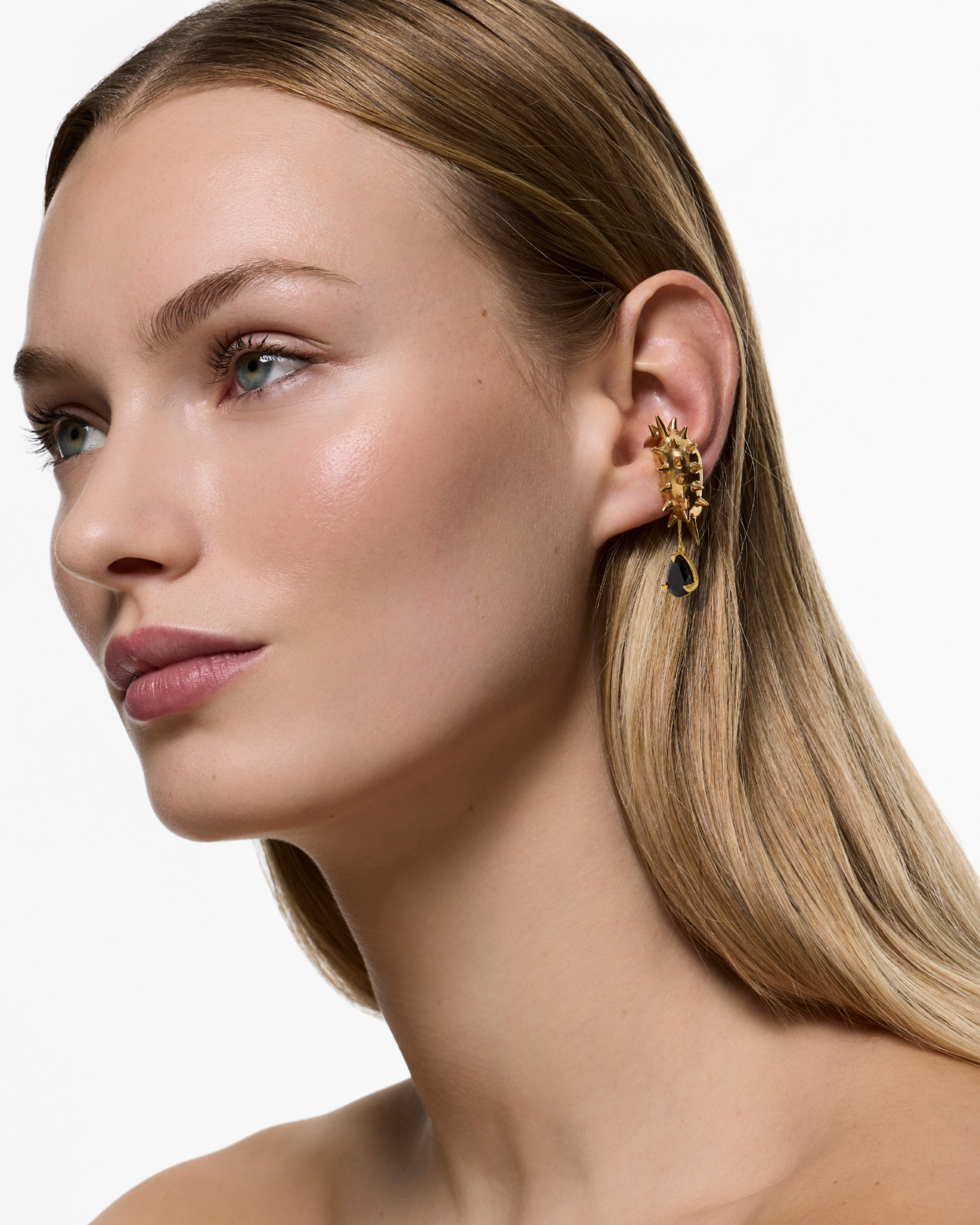 Model wearing the Blown Drop Spike Black Onyx Ear Cuff in Gold Vermeil with sculptural spike detailing and a suspended black onyx gemstone.