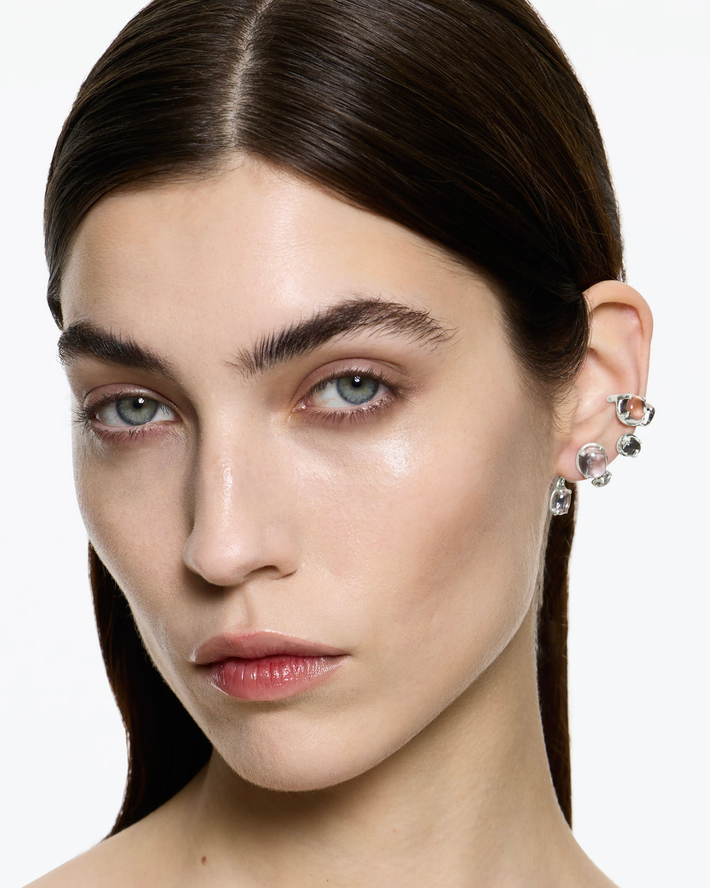 Model wearing Climax Clear Ear Set in rhodium vermeil with sculptural ear cuff and cascading earring