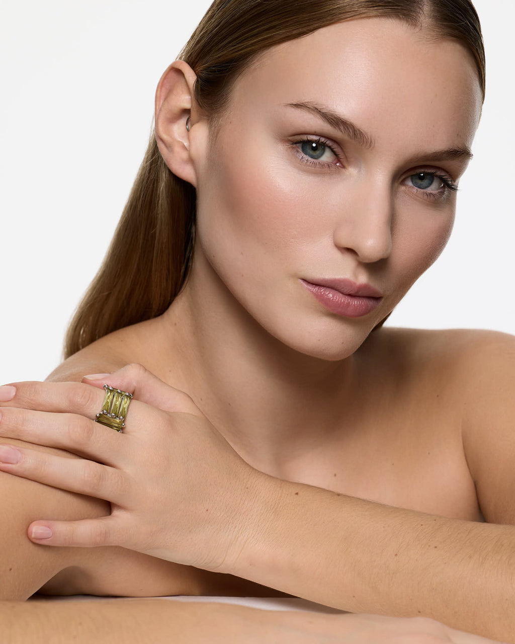designer silver ring light green stones worn by female model