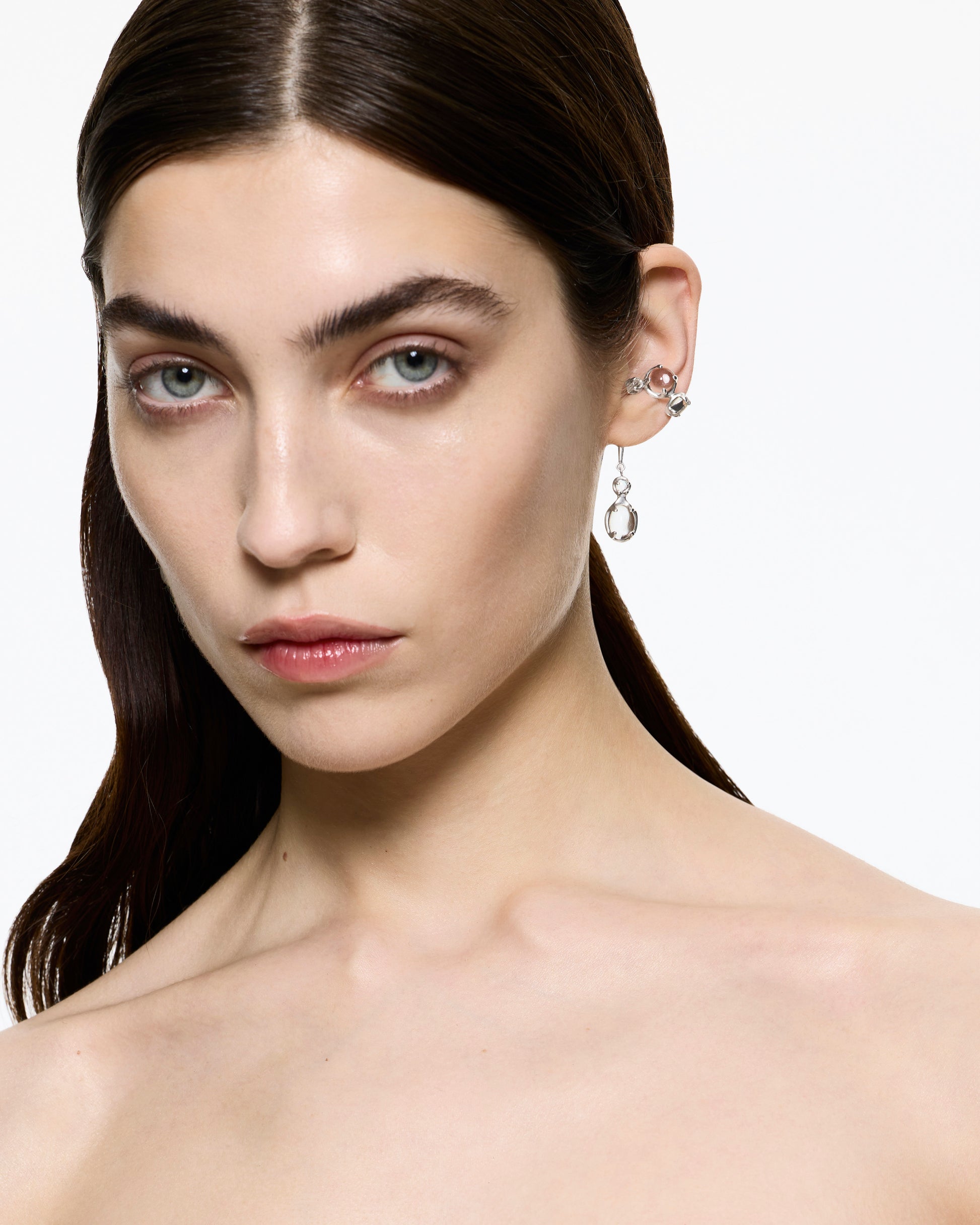 Model wearing the Alan Crocetti Drip Clear Ear Cuff in sterling silver with clear CZ cabochon stones