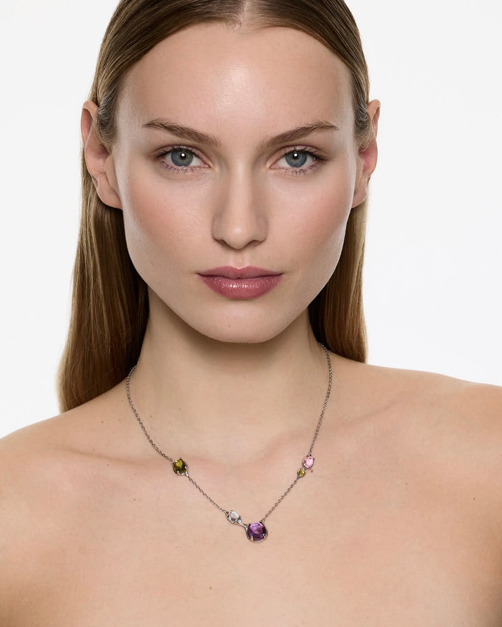 model wearing Alan Crocetti asymmetrical gemstone necklace tropical colours