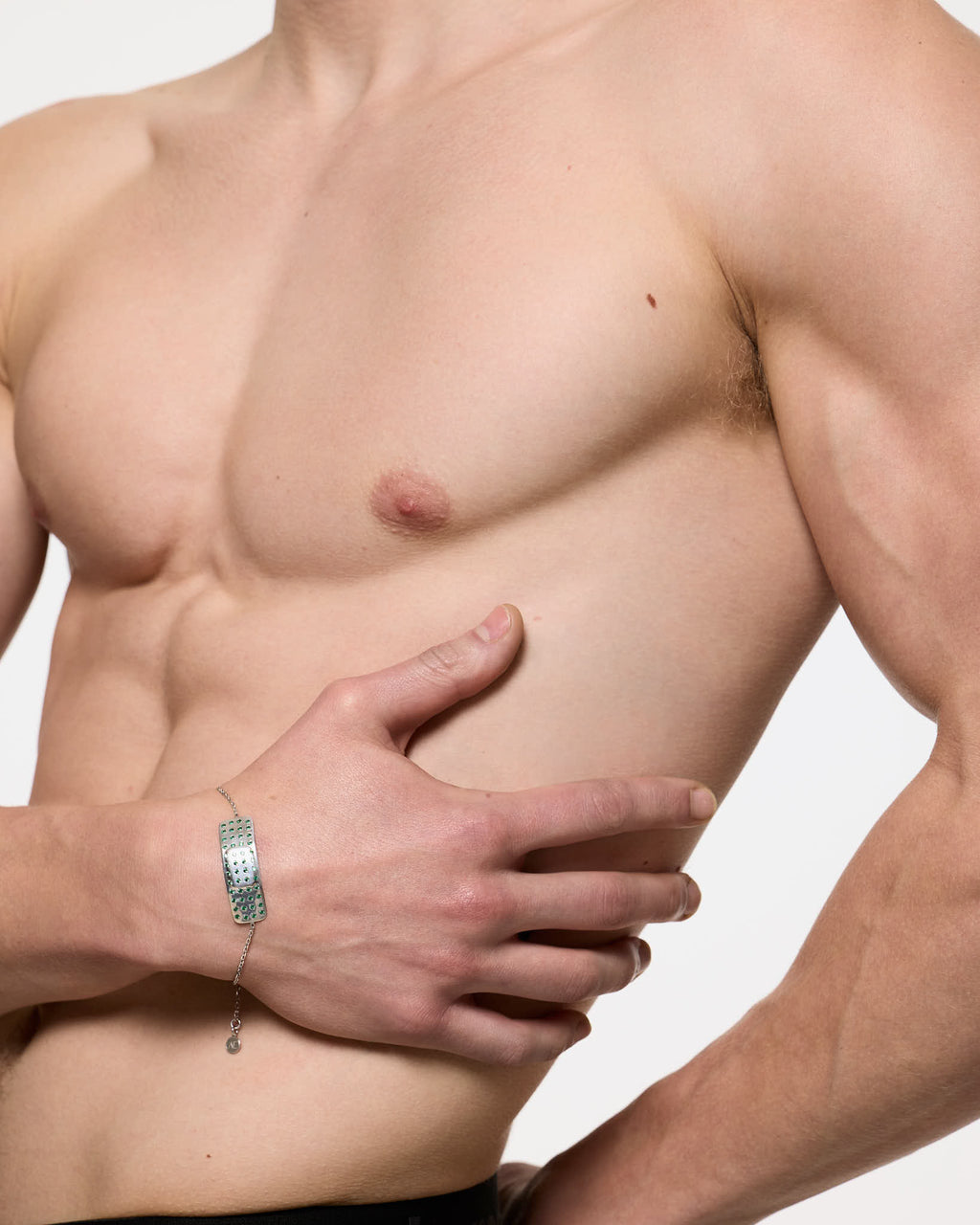 Model wearing synthetic emerald encrusted mini plaster bracelet rhodium vermeil Alan Crocetti