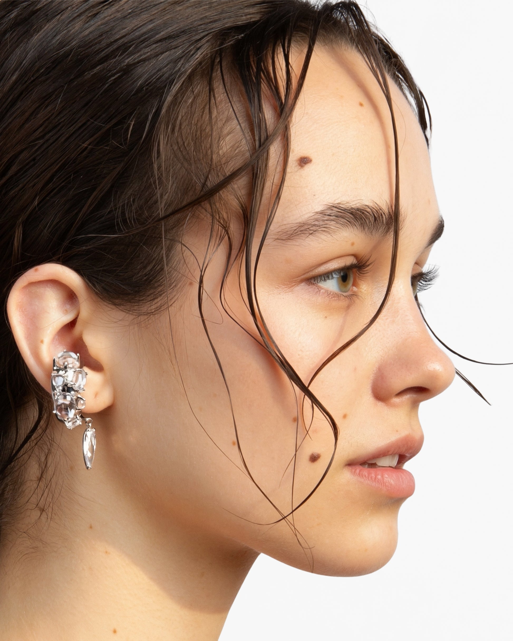 Model wearing Alan Crocetti clear stone ear cuff sculptural silver