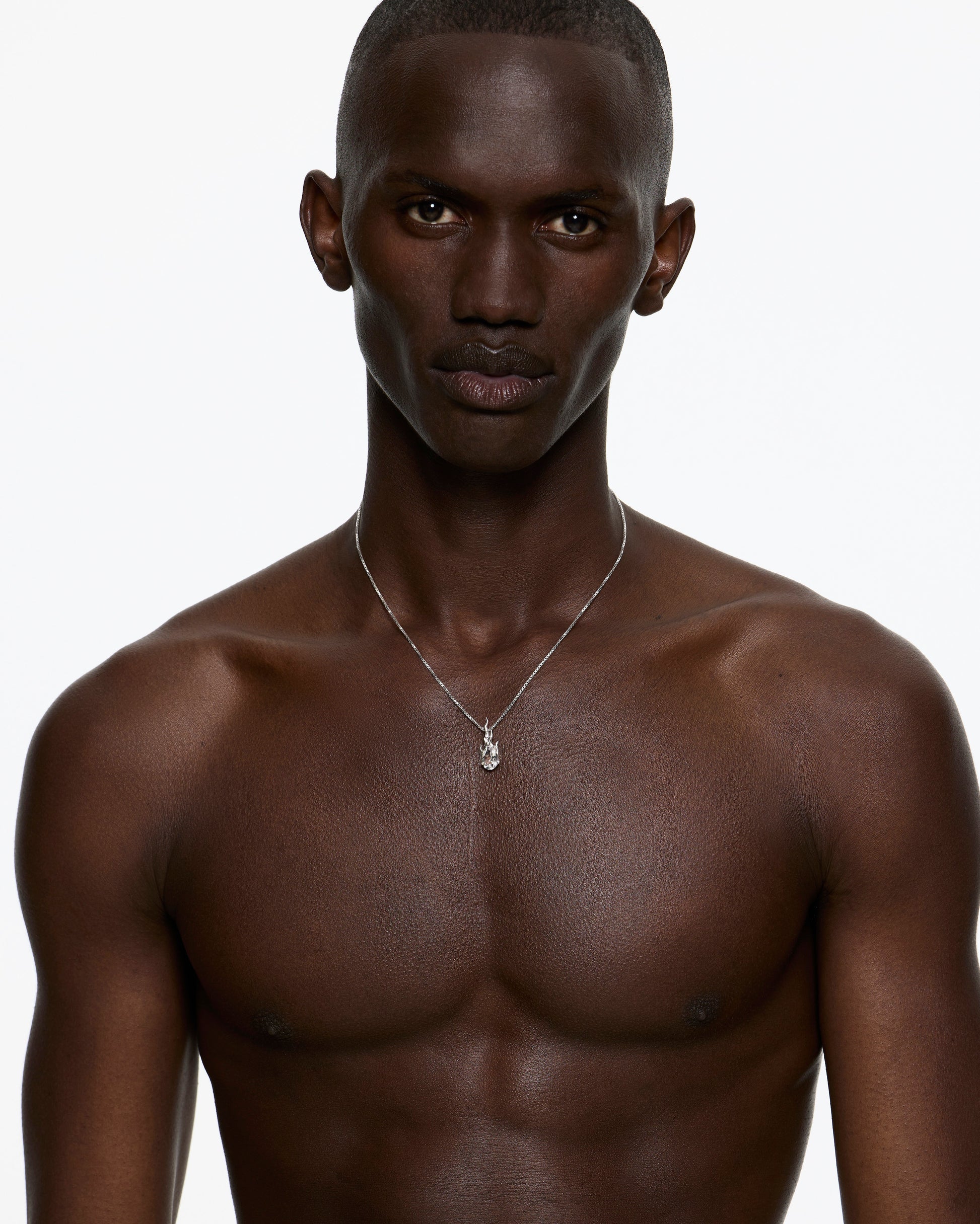 Model wearing Alan Crocetti Gem In Heat Necklace with white topaz pendant
