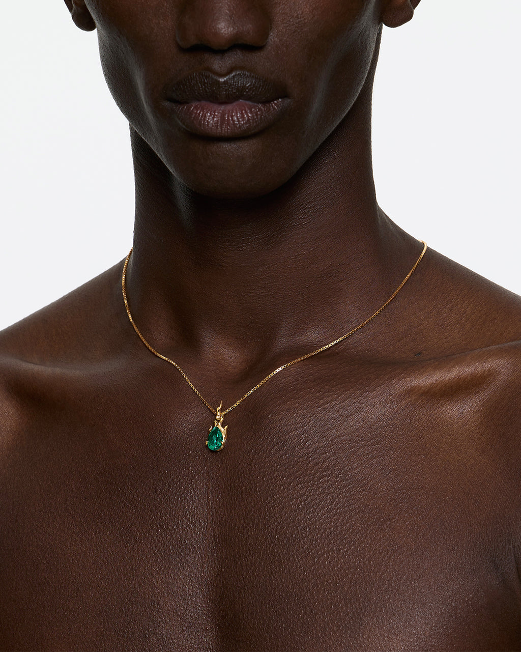 Model wearing mini gem in heat lab grown emerald flame necklace gold vermeil close-up