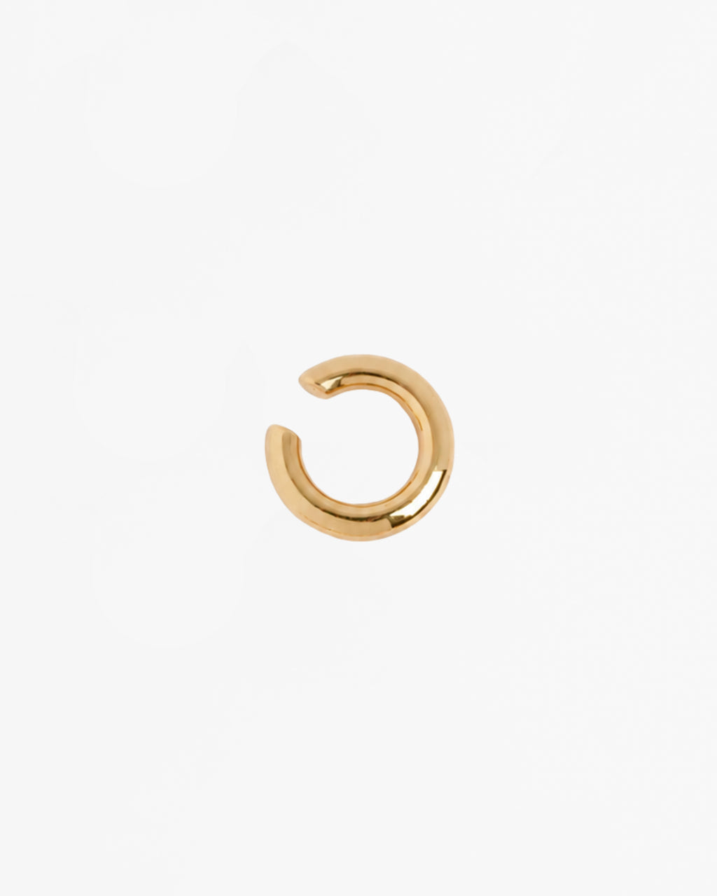 Mini Loophole Earcuff in gold vermeil featuring a smooth sculptural loophole aesthetic in sterling silver design by Alan Crocetti
