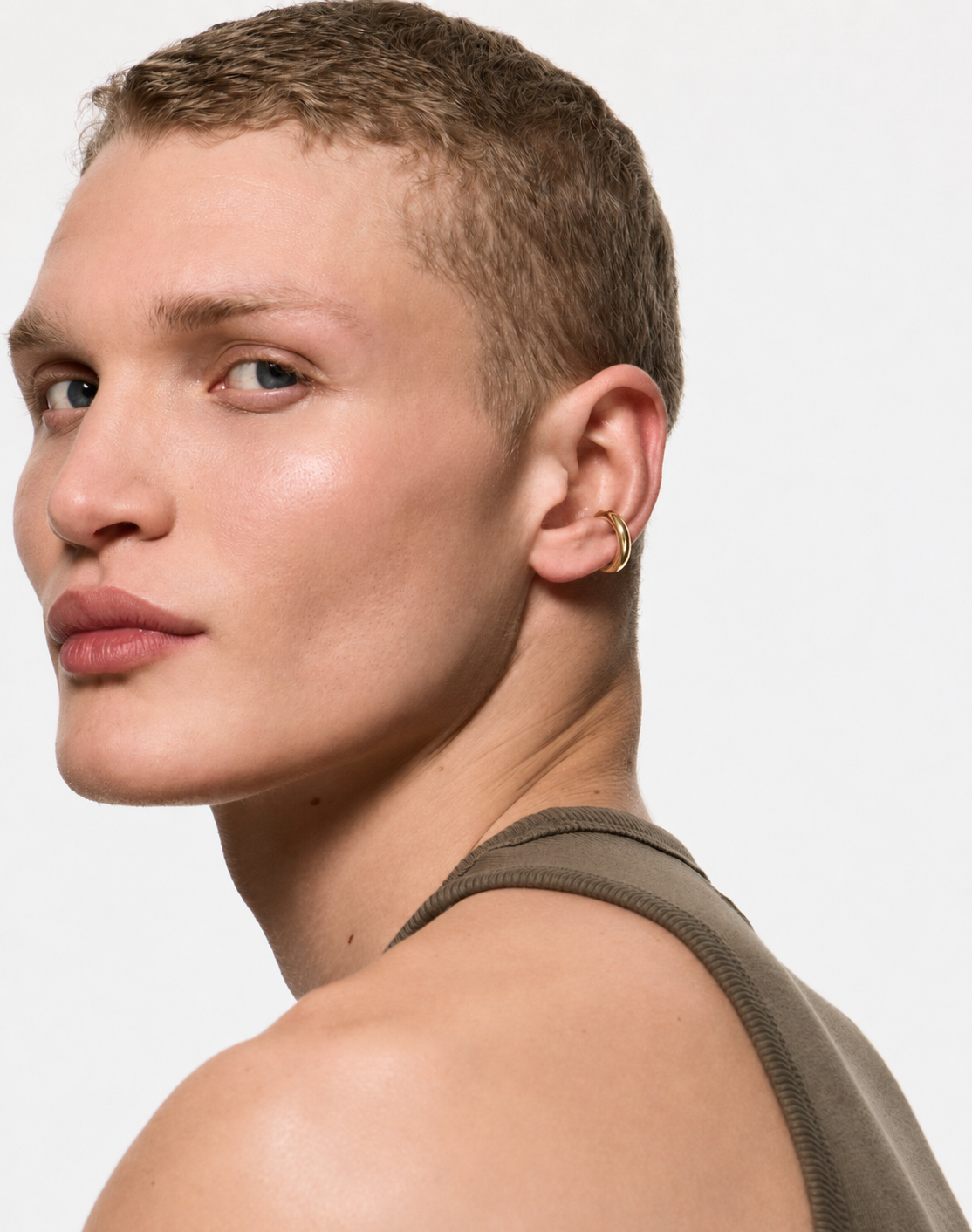 Mini Loophole Earcuff in gold vermeil featuring a smooth sculptural loophole aesthetic in sterling silver design by Alan Crocetti worn on model