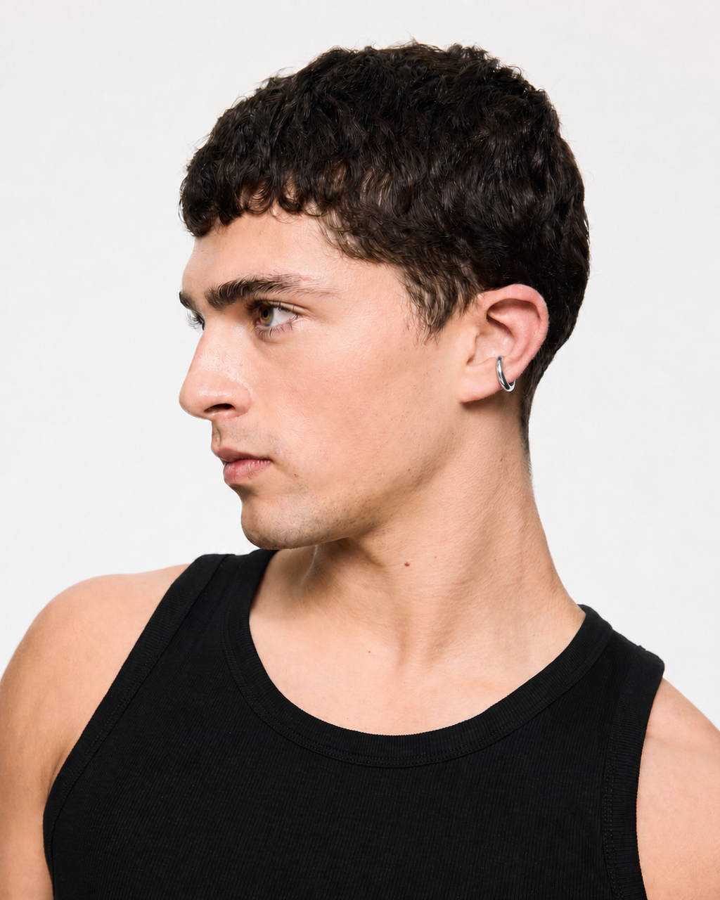 Mini Loophole Earcuff in gold vermeil featuring a smooth sculptural loophole aesthetic in sterling silver design by Alan Crocetti worn by model