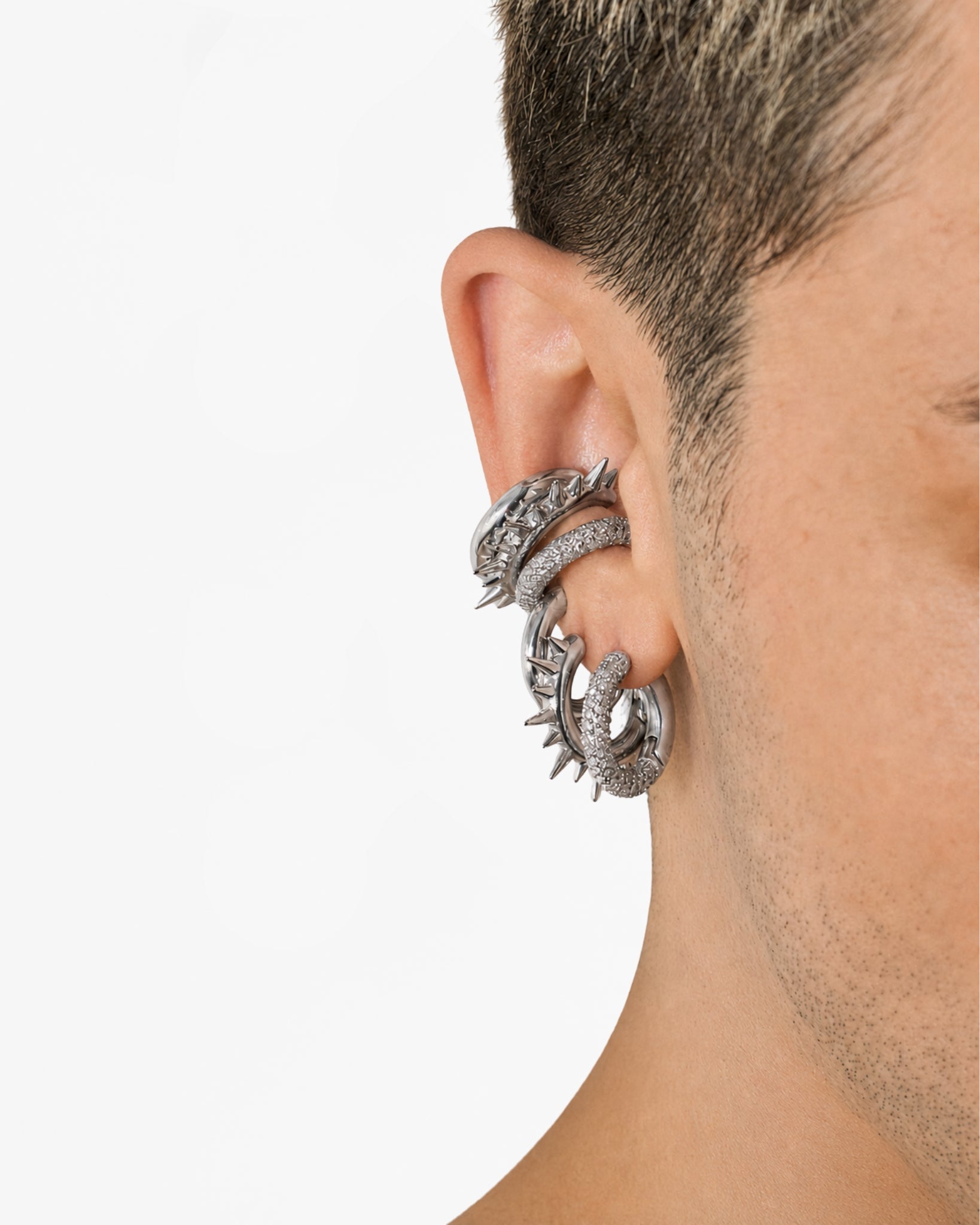 Model wearing the Mini Loophole stack in Rhodium Vermeil showcasing a minimalist contemporary unisex styling aesthetic by Alan Crocetti.