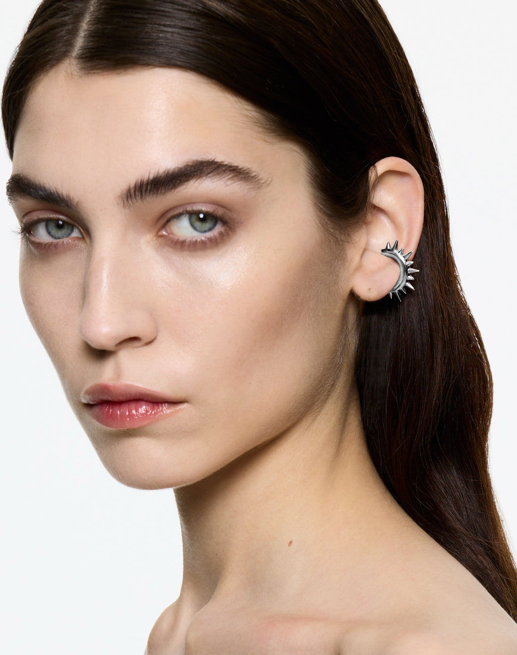 Mini Loophole Spur Ear Cuff — sculptural sterling silver spiked ear cuff with rhodium vermeil finish by Alan Crocetti worn by model