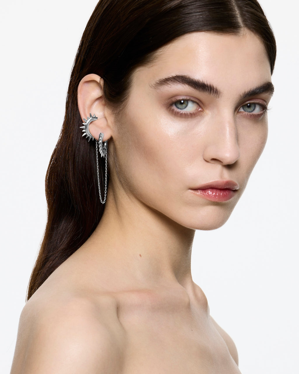 Model wearing Mini Loophole Spur Earset Rhodium Vermeil— sterling silver sculptural spur hoop earset with connecting chain by Alan Crocetti