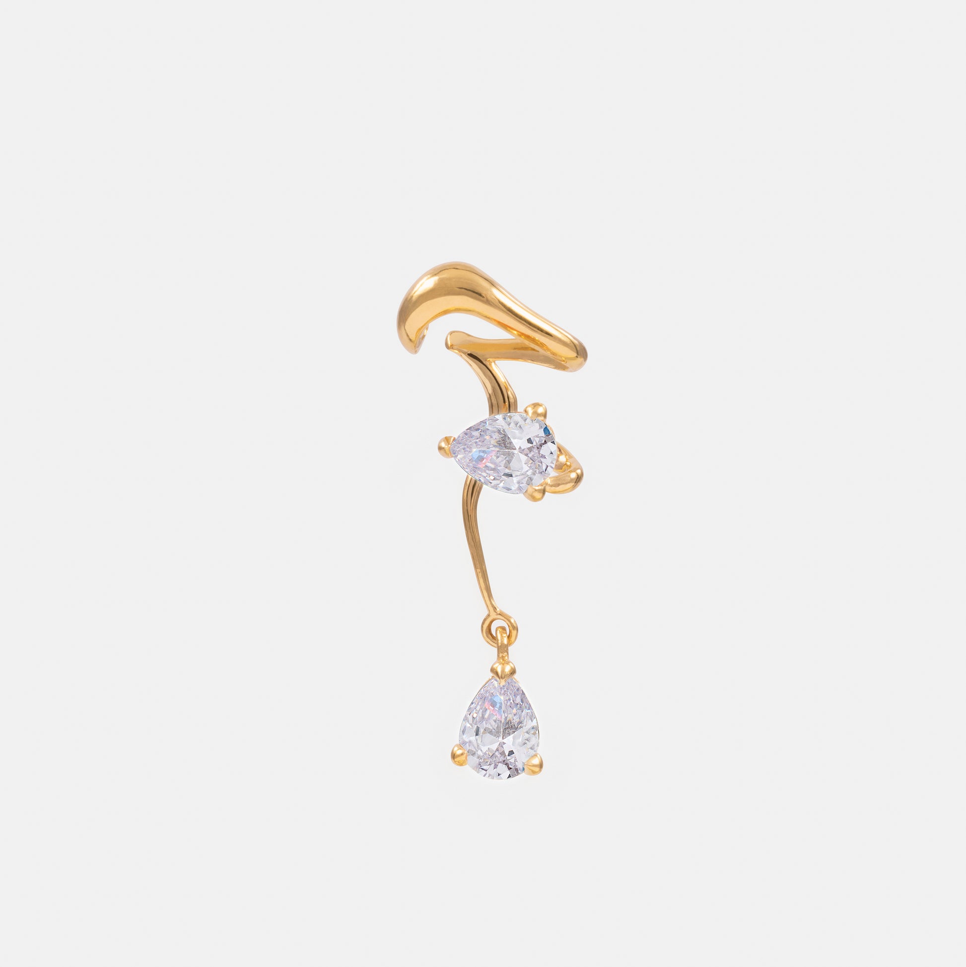 Gold ear cuff with clear gemstones on a white background