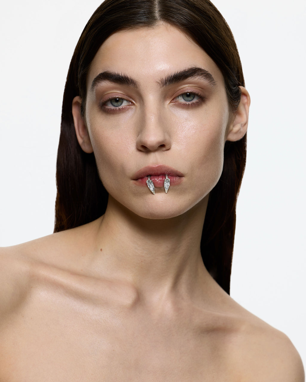 Model wearing ear mouth cuff sculptural silver jewellery