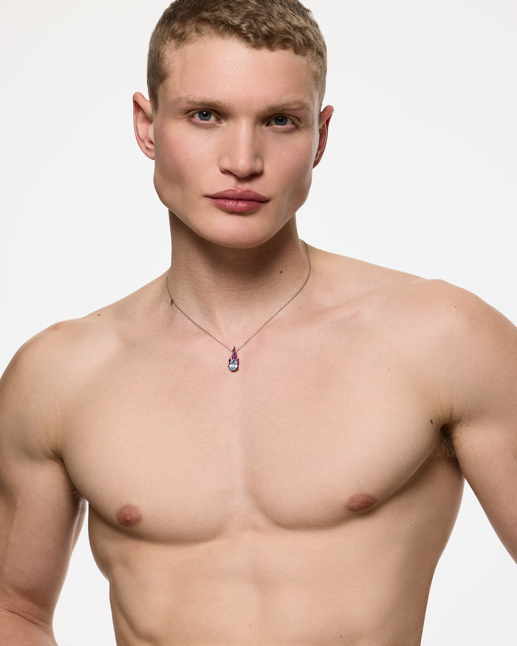 Male model wearing Mini Pink Gem in Heat sky topaz necklace in rhodium vermeil